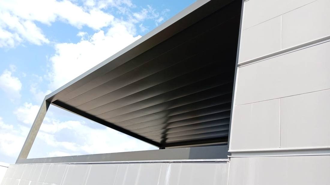 Umbre grey louvre awning against the sky at McDonald's Northmead