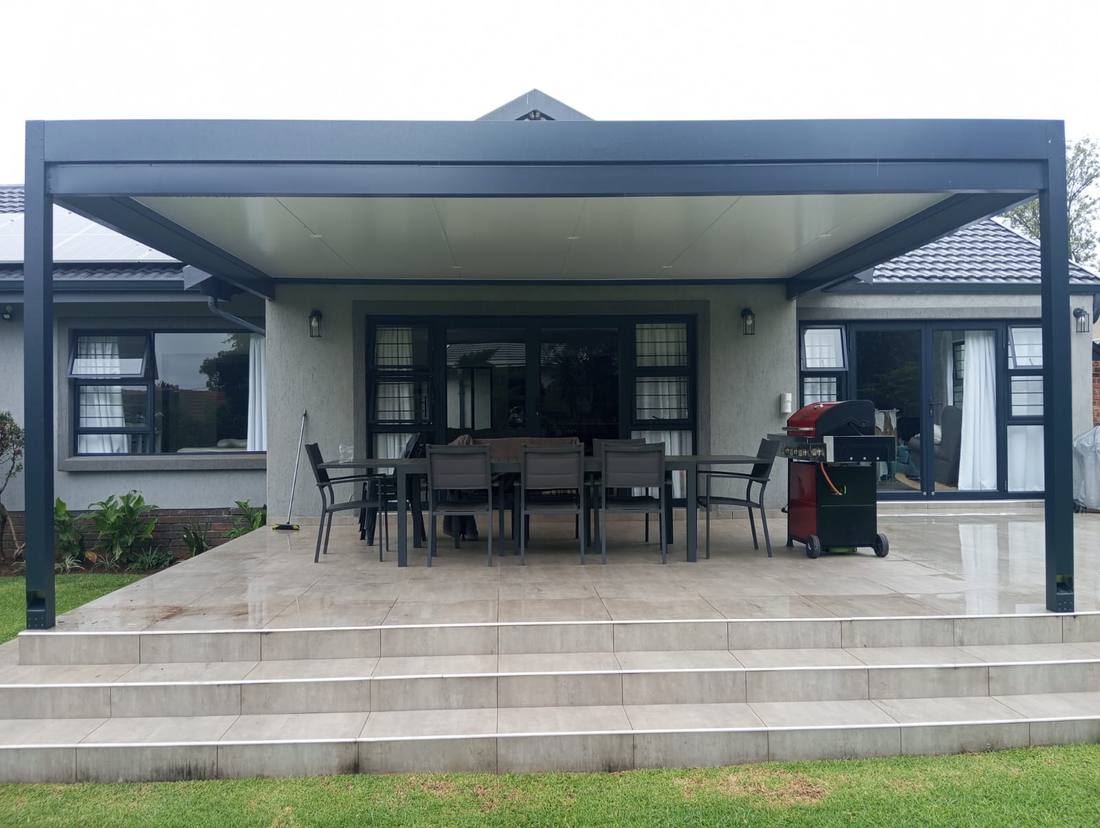 The charcoal frame and cream ceiling above the Benoni dining patio